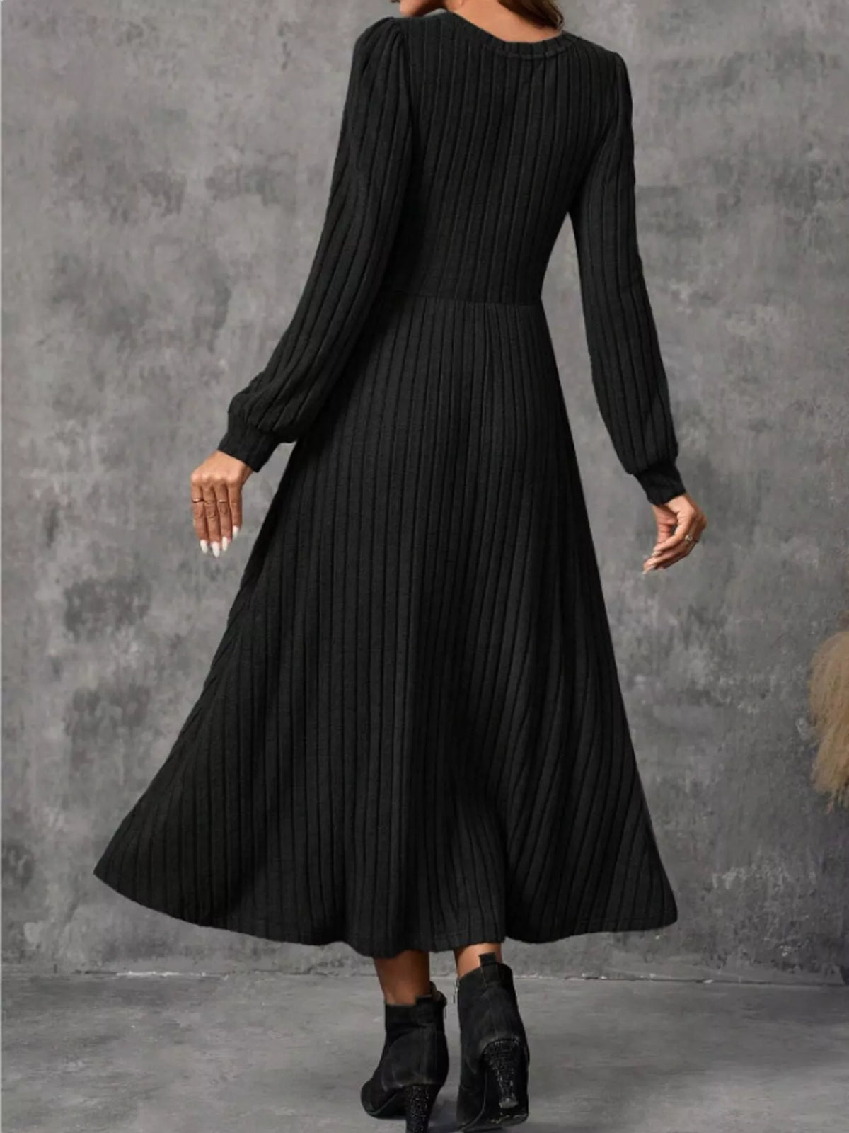 Black ribbed knit long-sleeve A-line midi dress, back view on model.