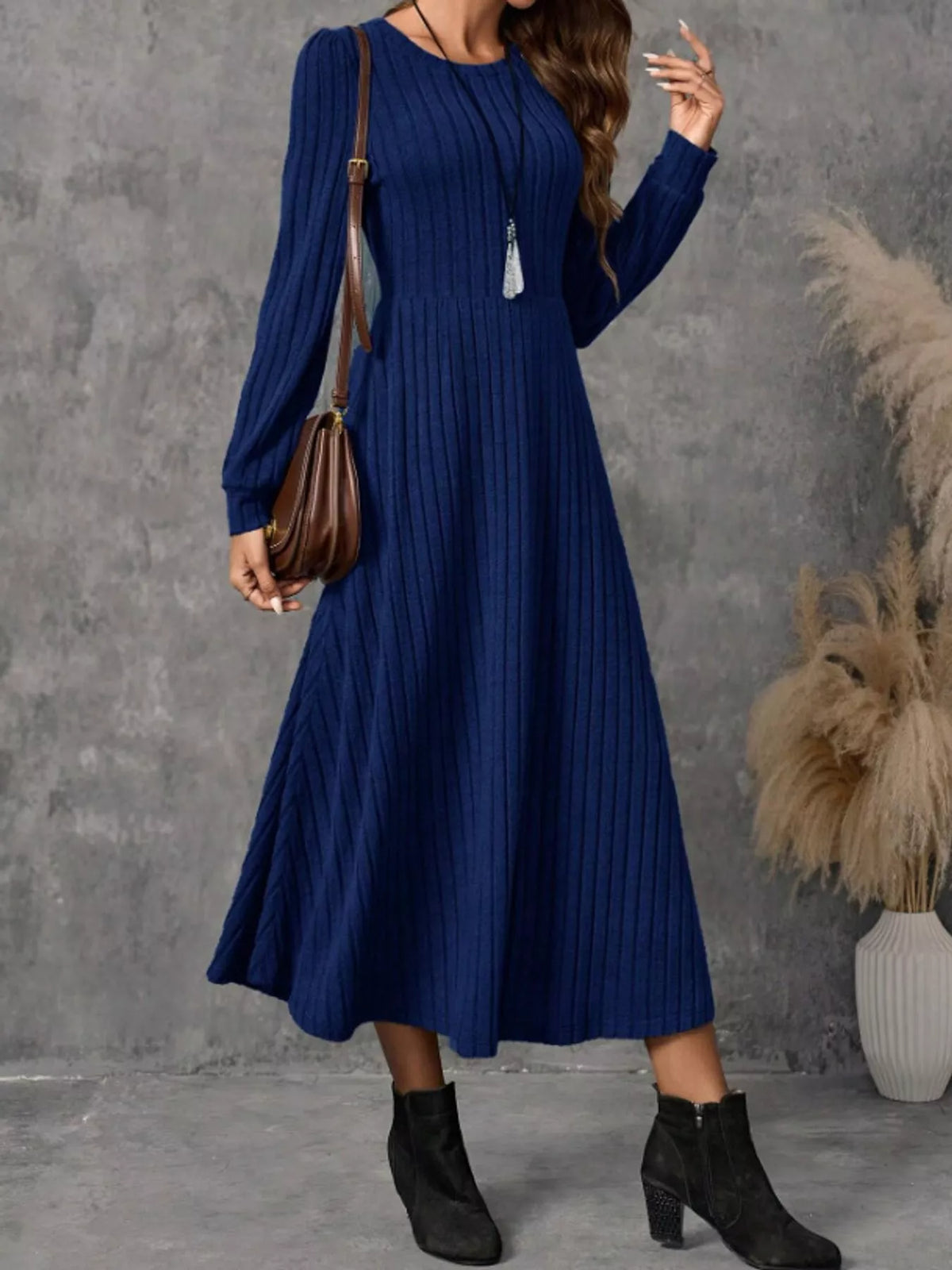 Royal Blue ribbed knit A-line midi dress with long sleeves, shown on a model carrying a brown shoulder bag.